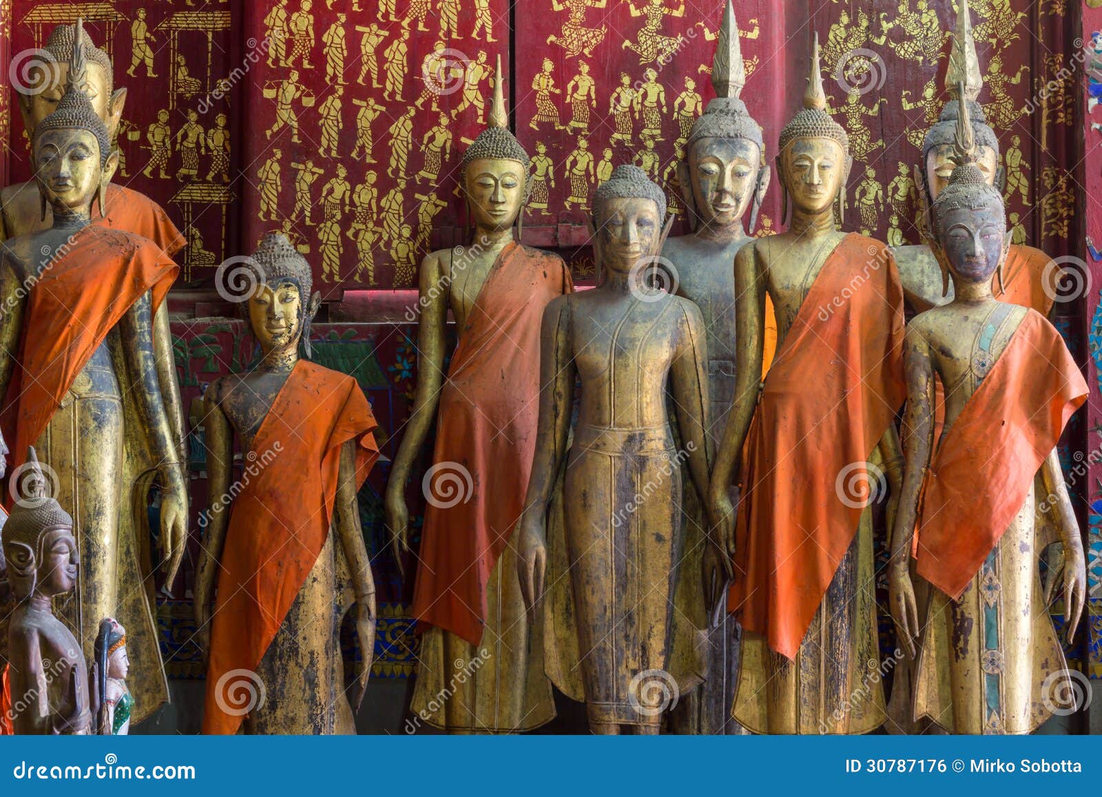 a group of buddha statues (standing)