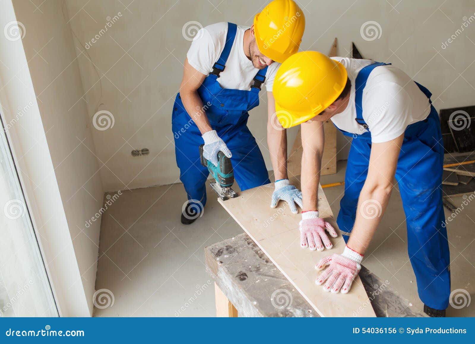 group of builders with tools indoors