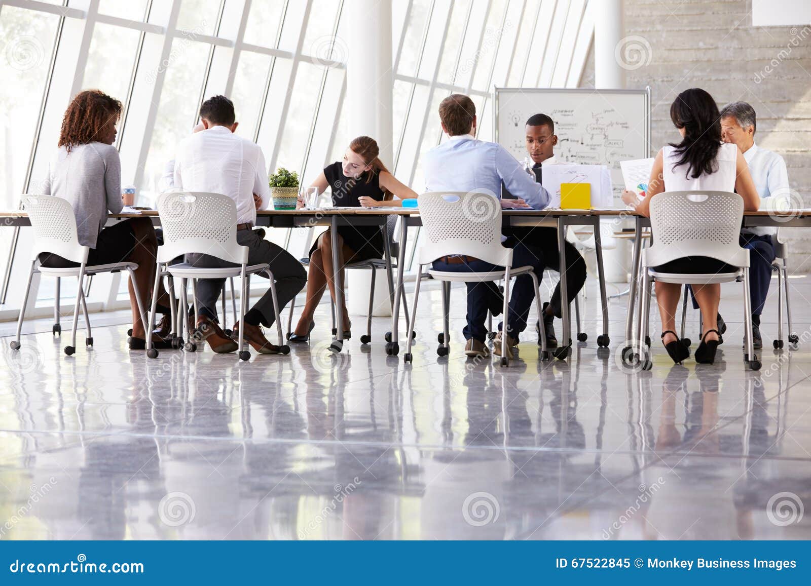 Group Business Meeting Around Table in Modern Office Stock Image
