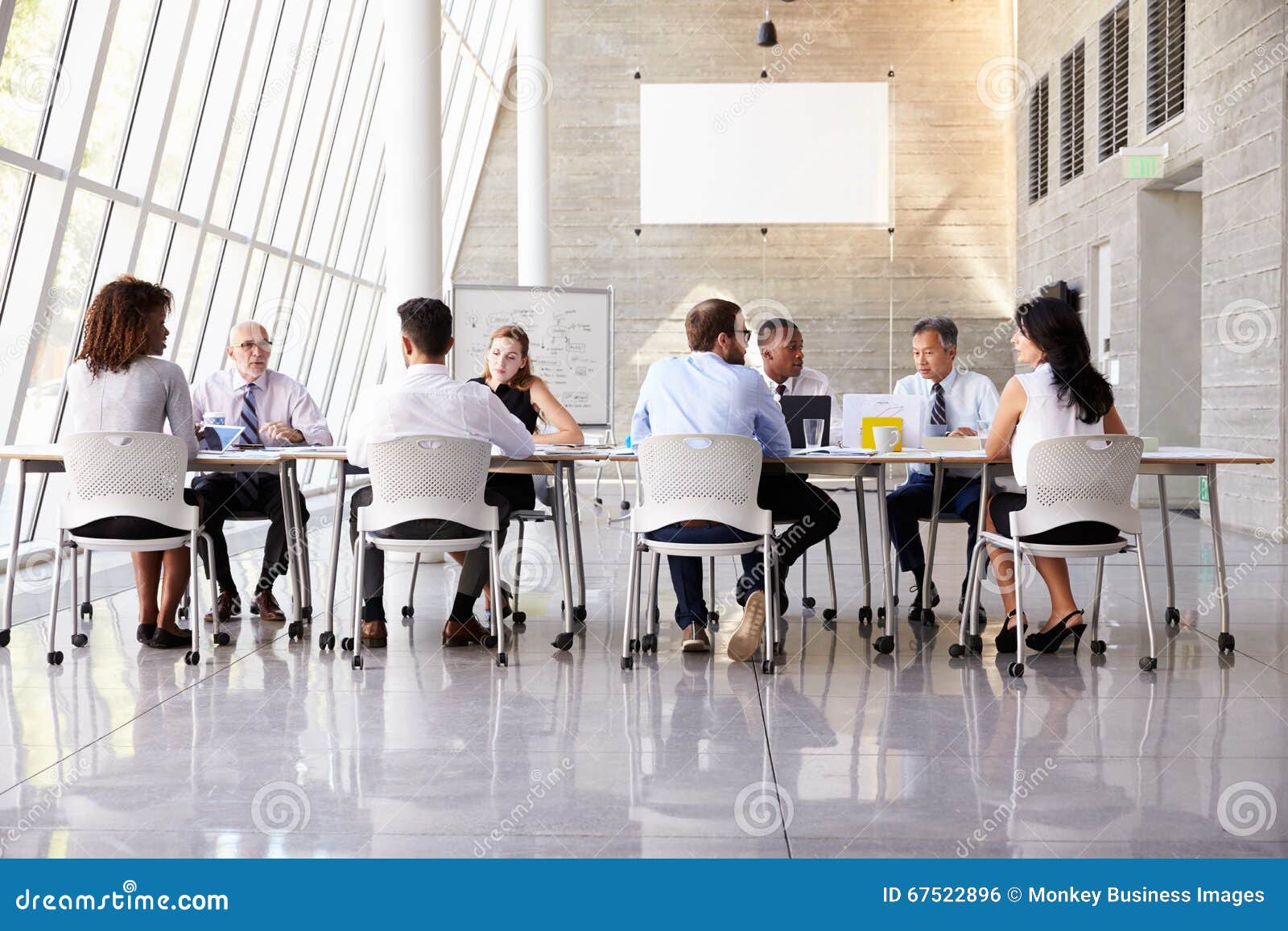 Group Business Meeting Around Table in Modern Office Stock Photo