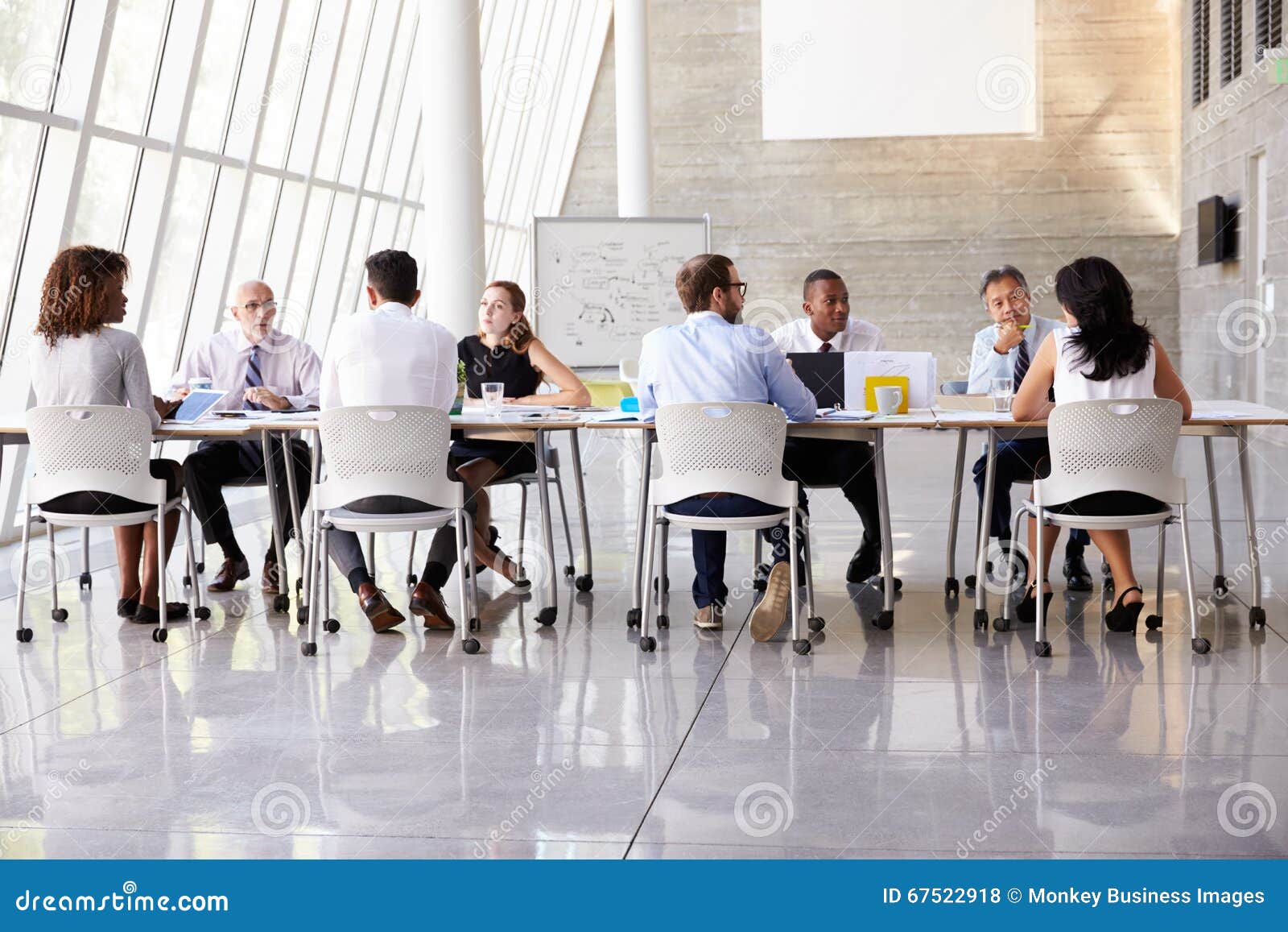 Group Business Meeting Around Table in Modern Office Stock Photo