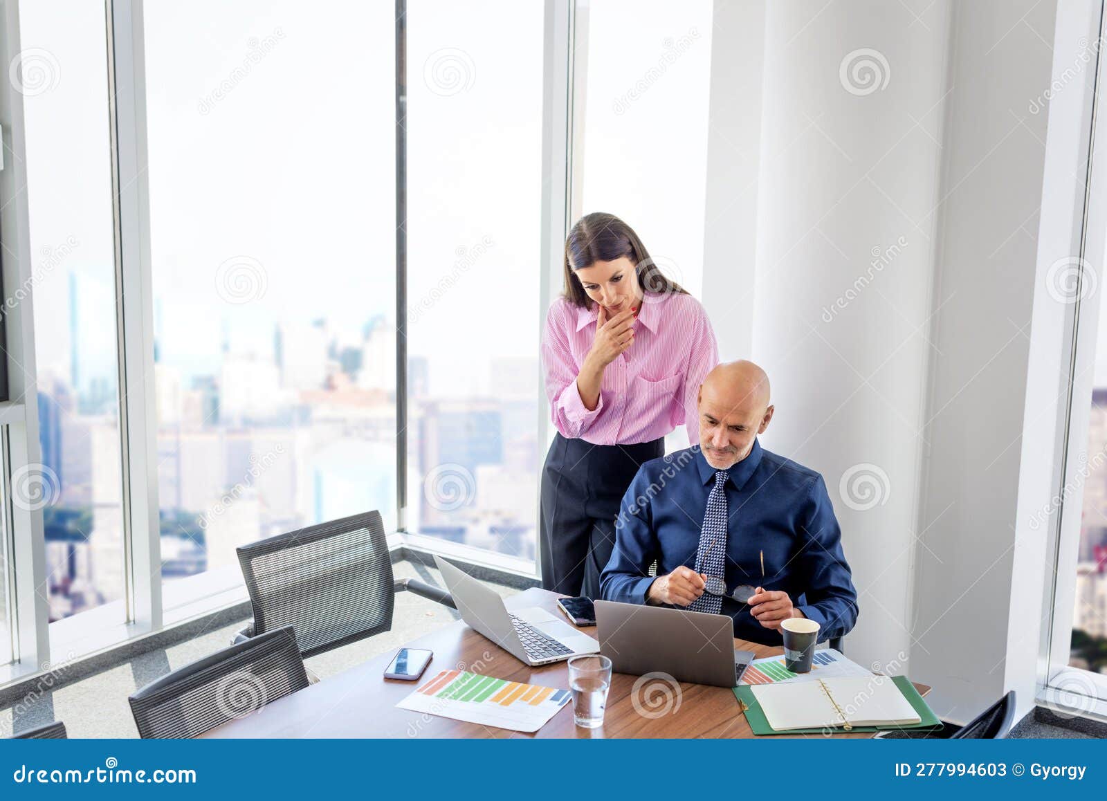 businesswoman and businessman using laptops and working together at the office