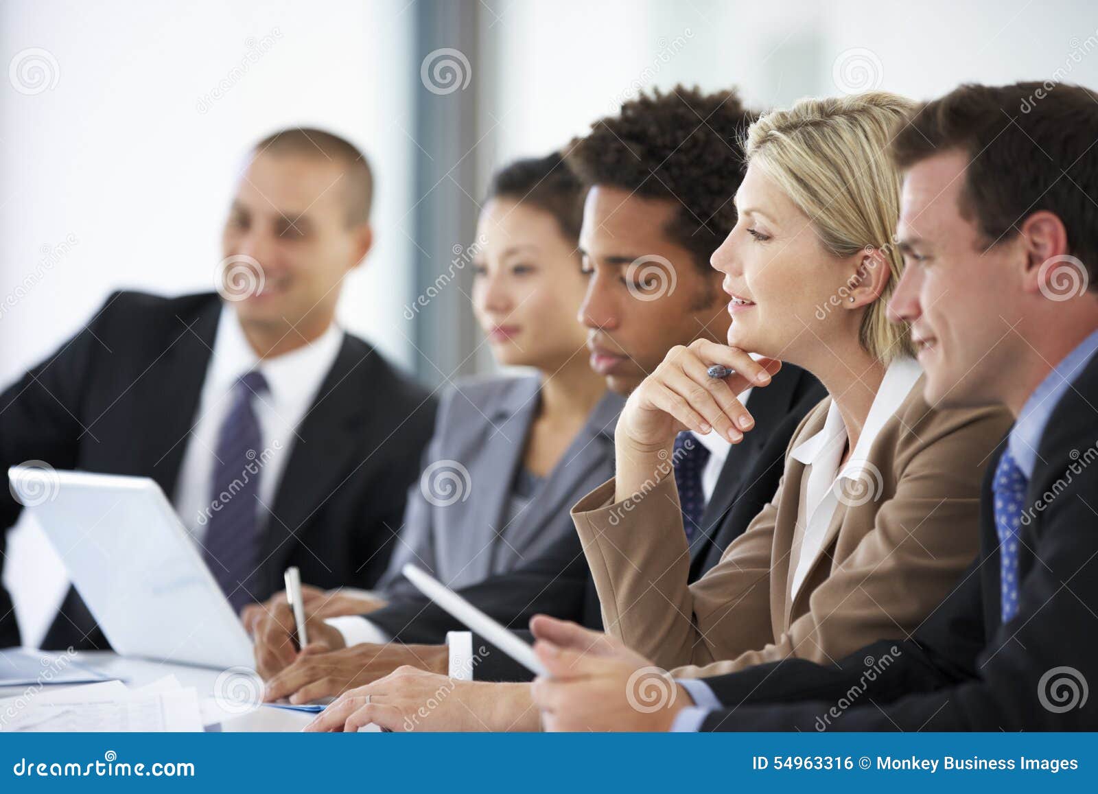Group of Business People Listening To Colleague Addressing Office