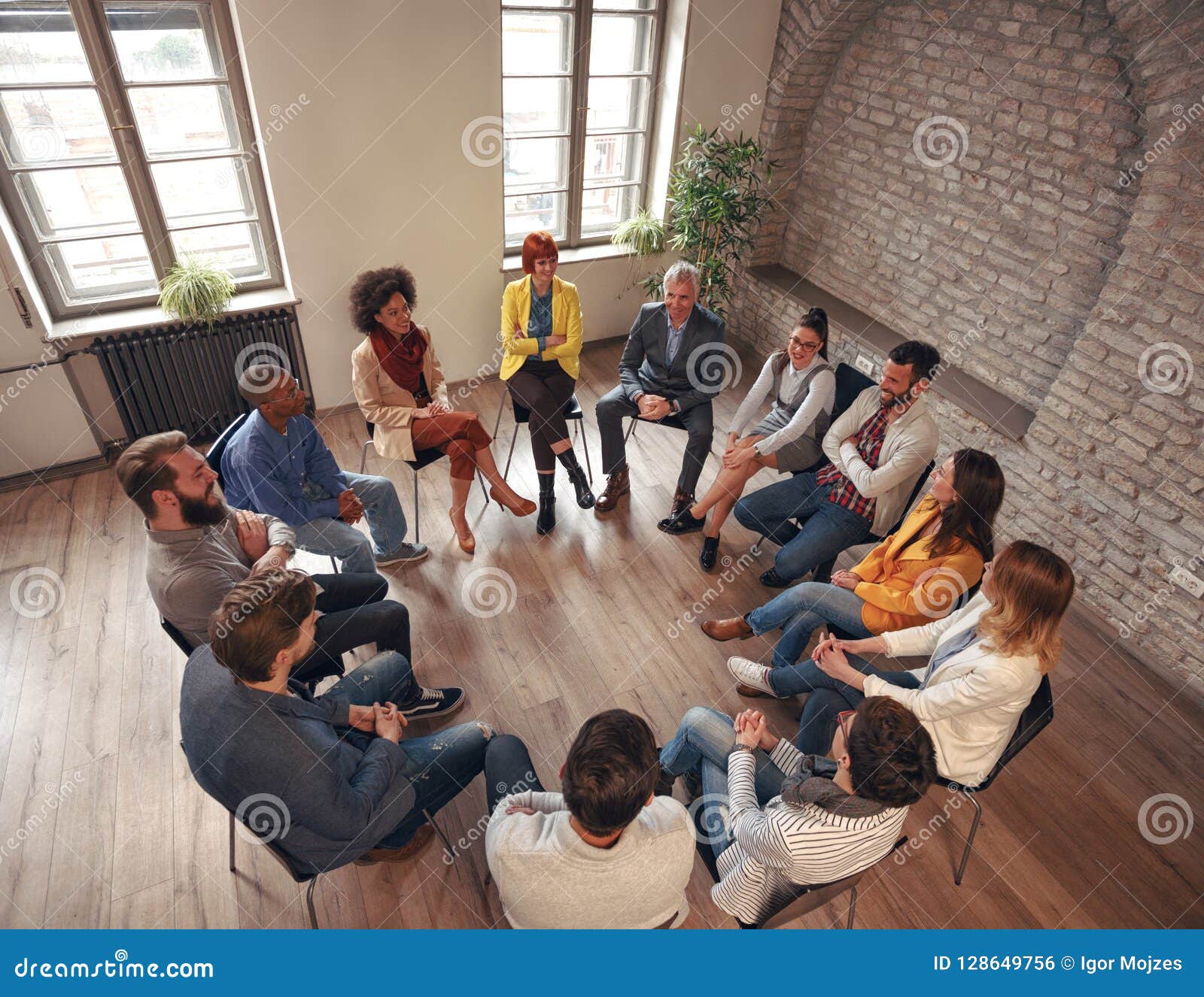 Business People Sitting at Circle in Board Room and Discussing Stock