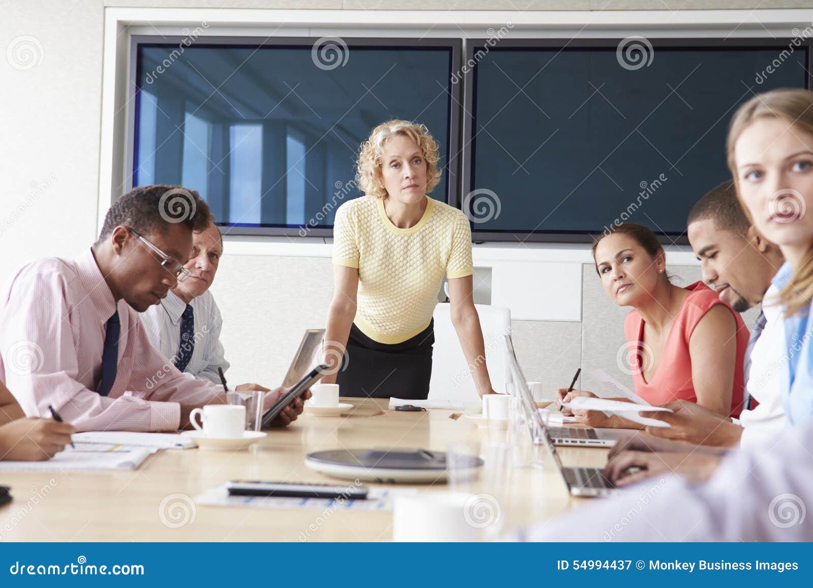 Group of Businesspeople Meeting Around Boardroom Table Stock Image