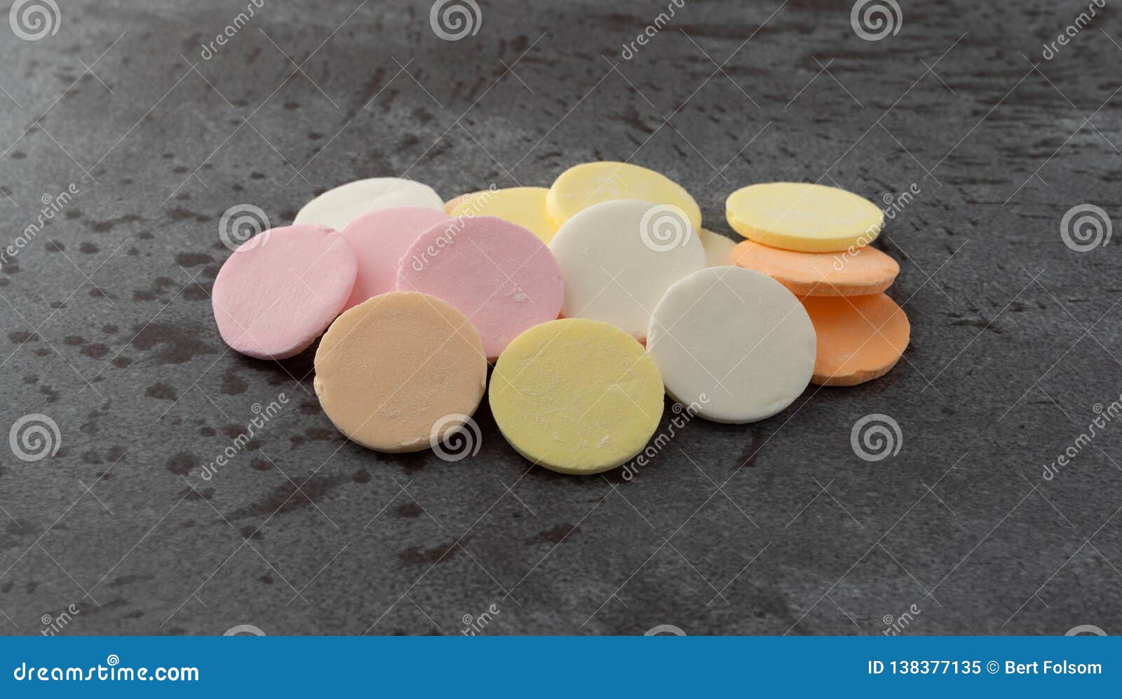 Group of Candy Wafers on a Gray Background Illuminated with Natural