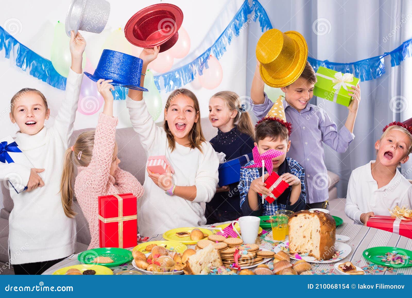 Cheerful Children Exchanging Gifts with Each Other during Party Stock ...