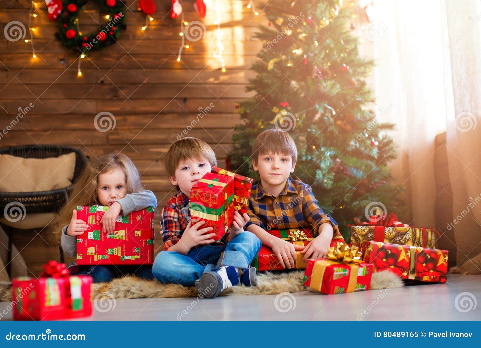 group children with christmas presents. dreamers.