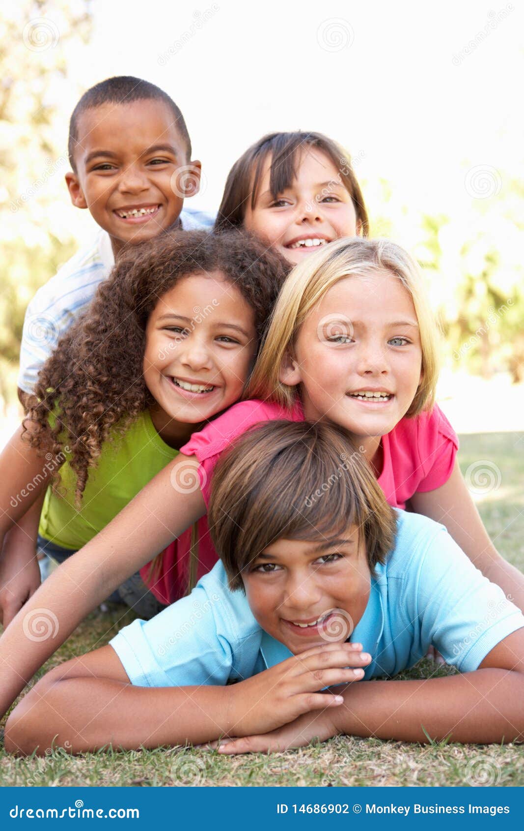 group of children piled up in park