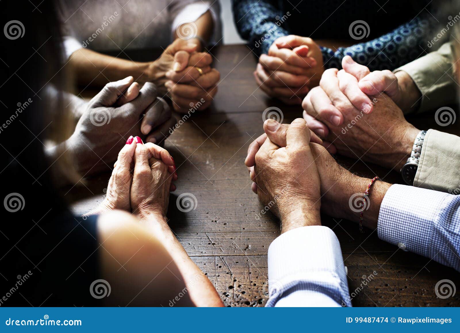 group of christian people are praying together