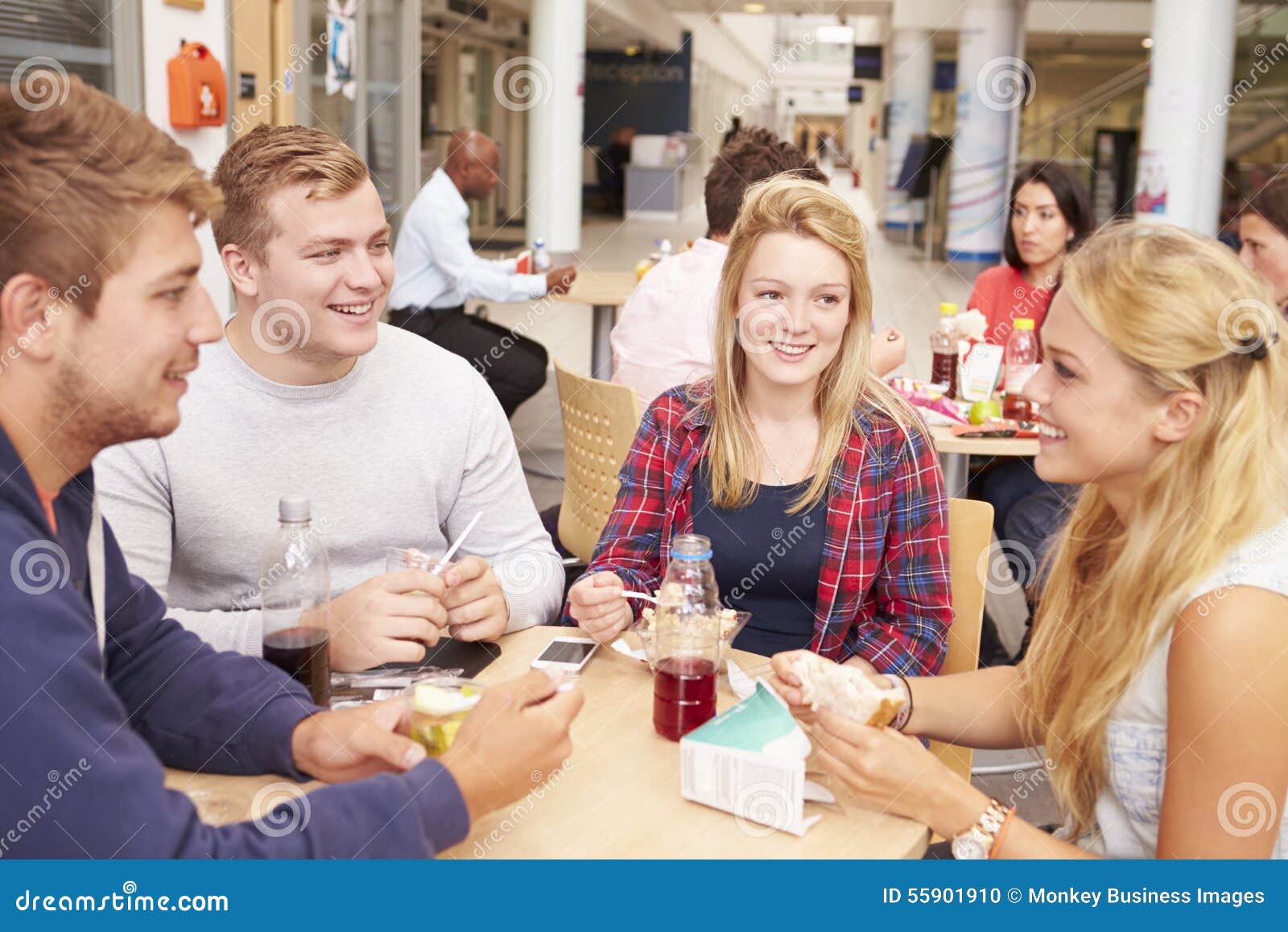 Group Of College Students Eating Lunch Together Stock Photo - Image of