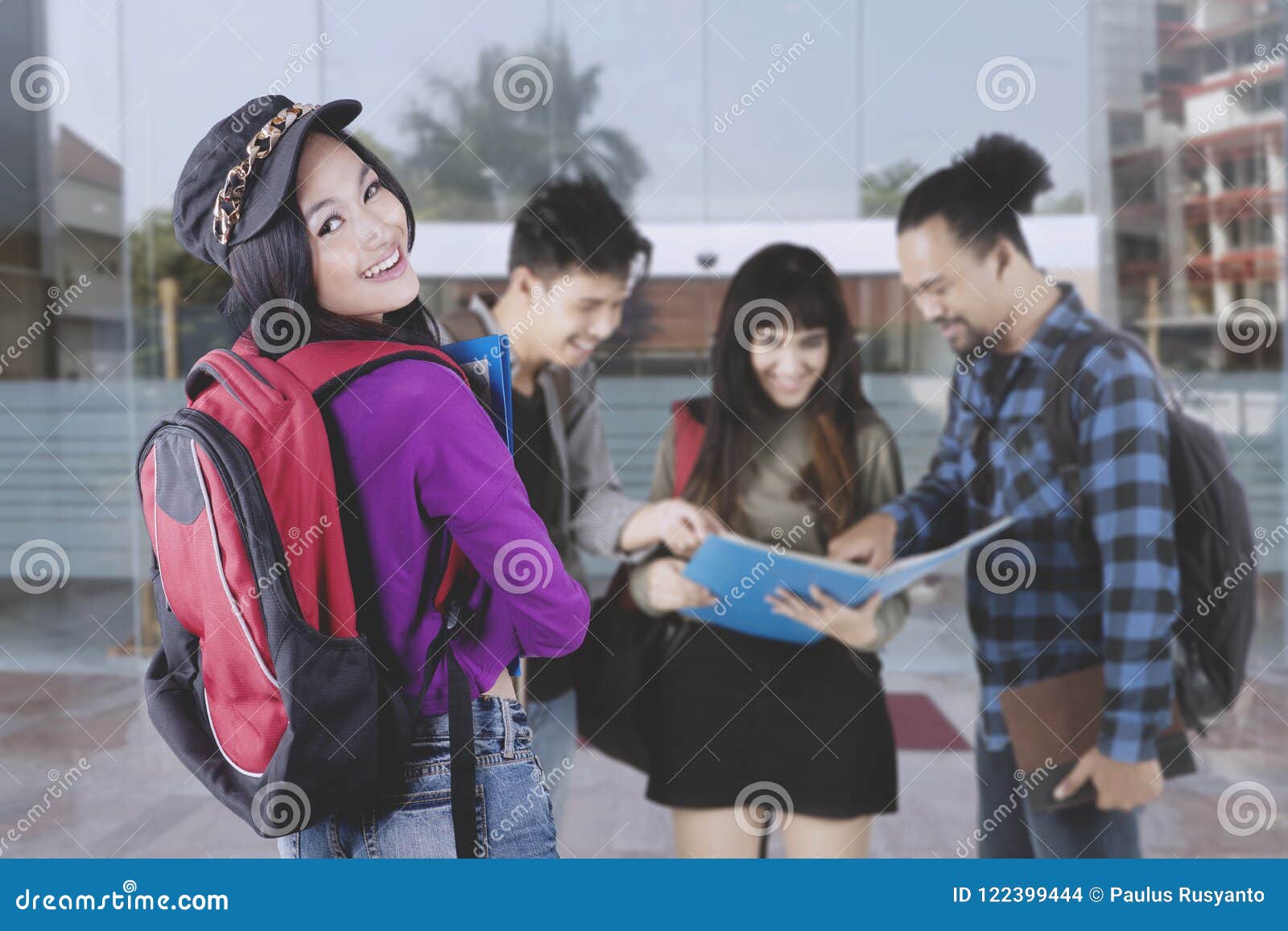 group of college students having a discussion outdoors