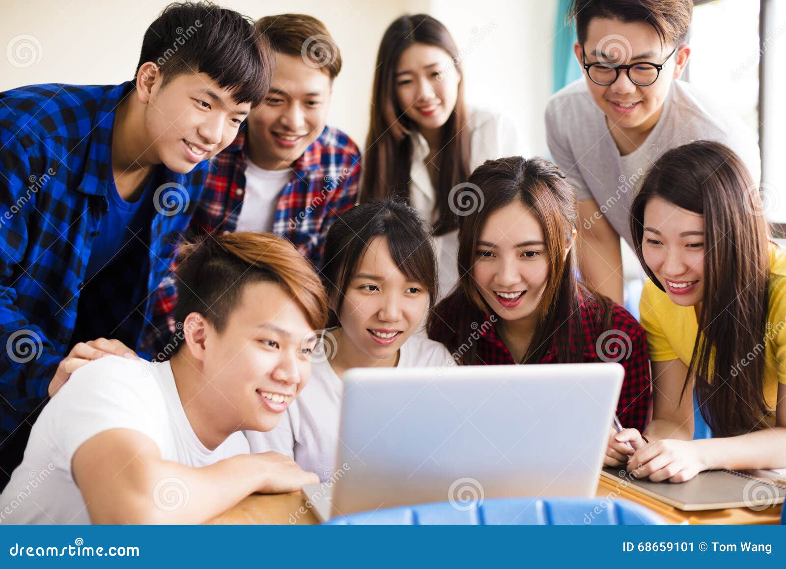 Group Of College Students Watching Laptop In Classroom ...