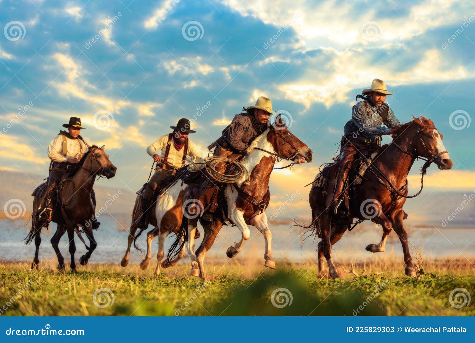 a group of cowboys riding horses.