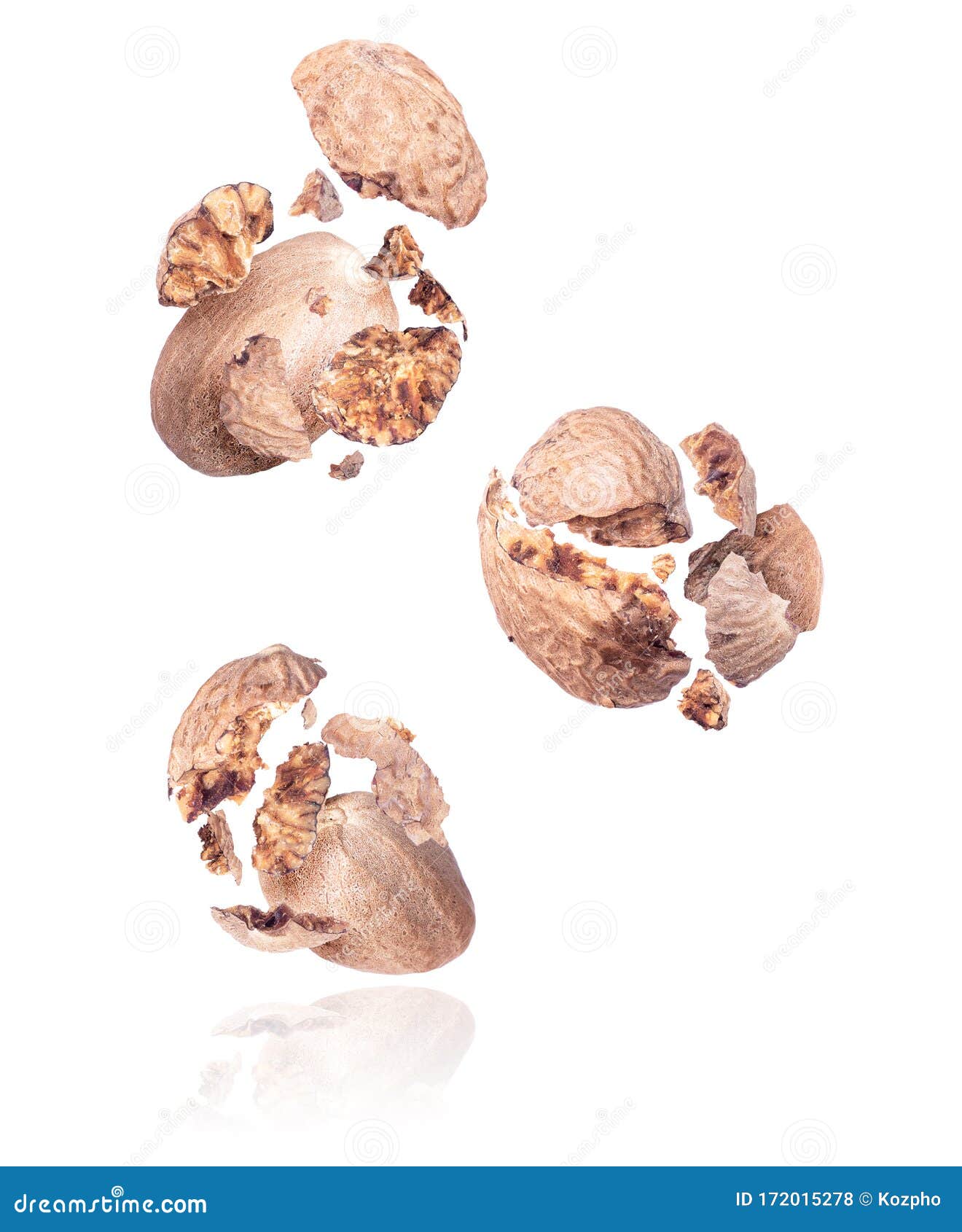 Group of Crushed Nutmeg in the Air Closeup on a White Background Stock