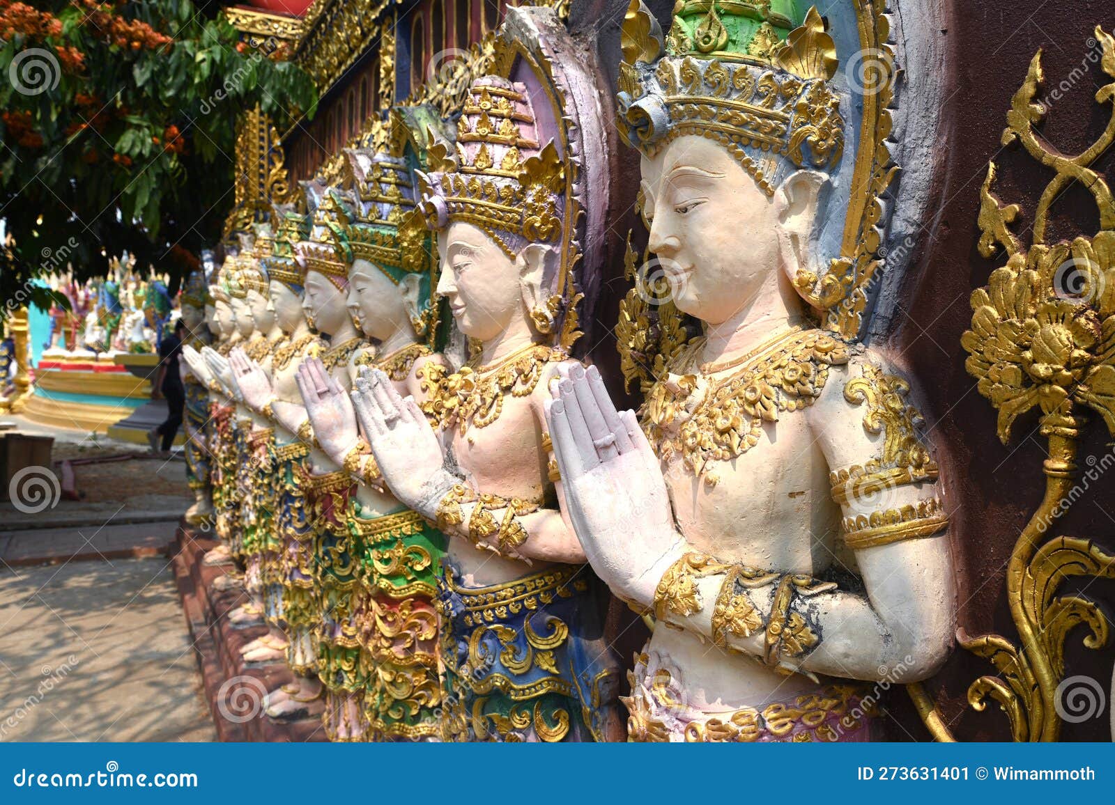 Deity Statues Standing in a Row on a Temple Wall in Thailand Stock
