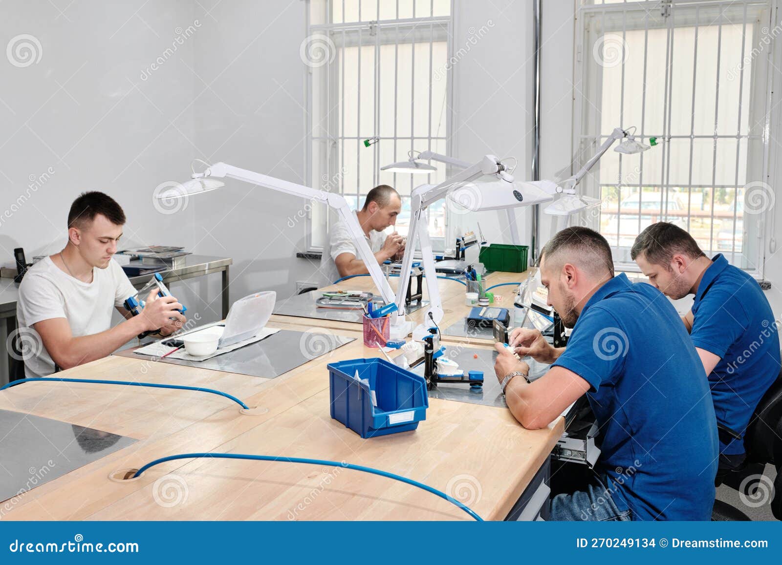 Group Dental Technicians Working in a Dental Laboratory. Production of