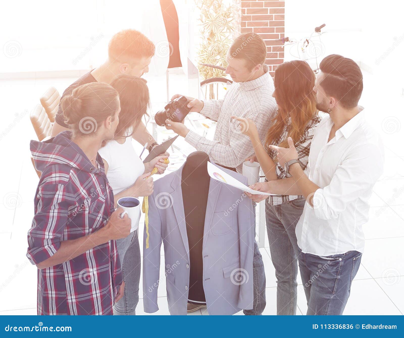 Group of Designers Discussing New Models of Men`s Clothing. Stock Photo ...