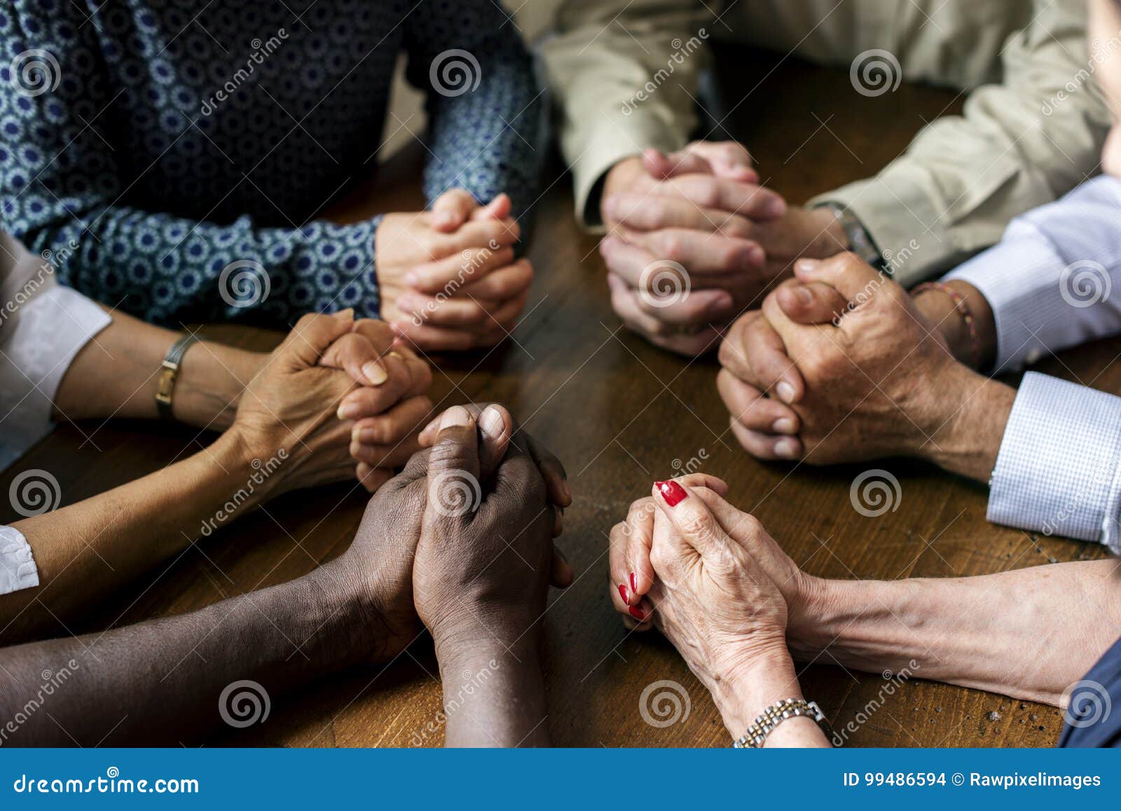 group of diverse hands are praying together
