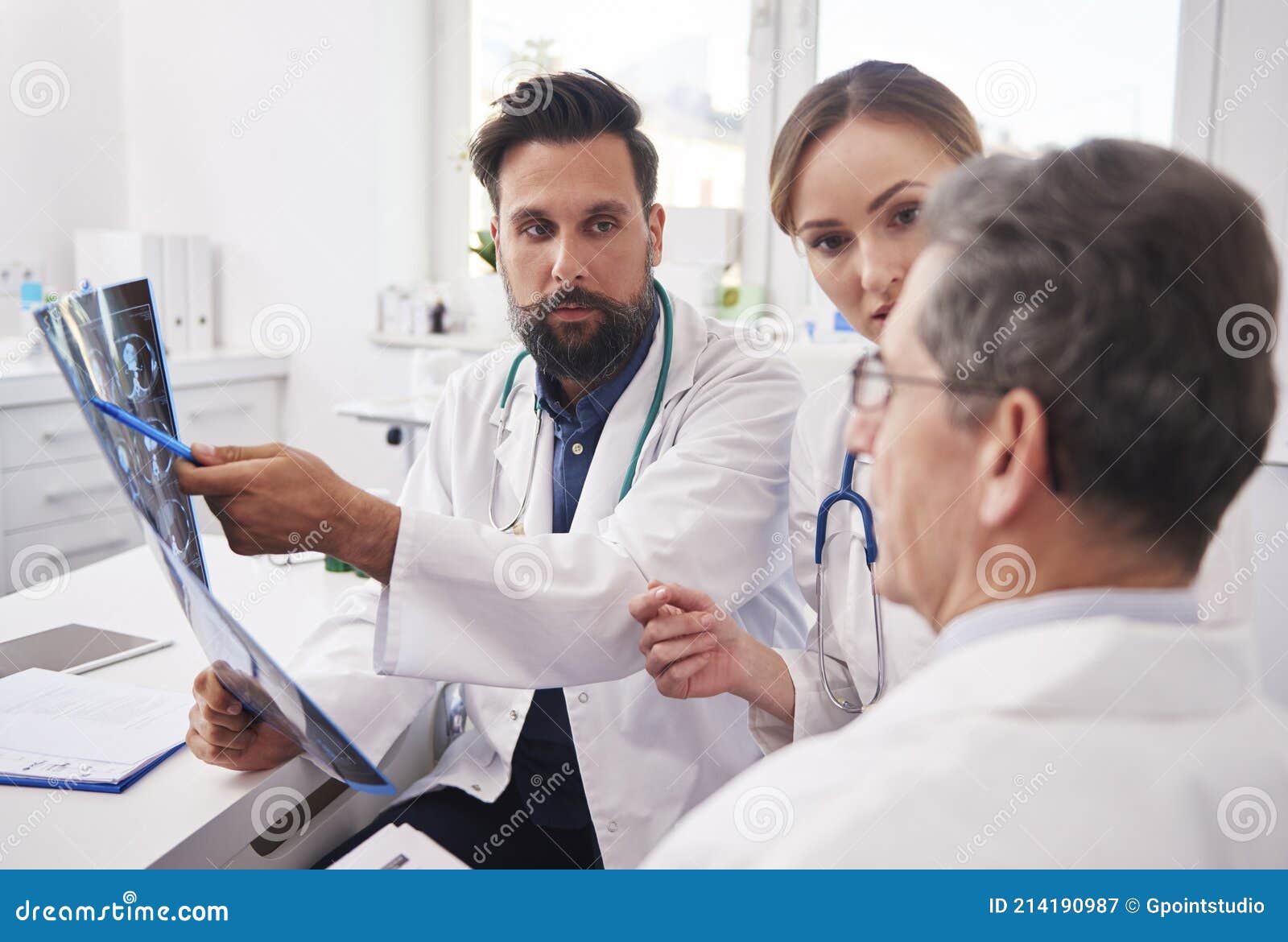 group of doctors looking at the results of the radiology