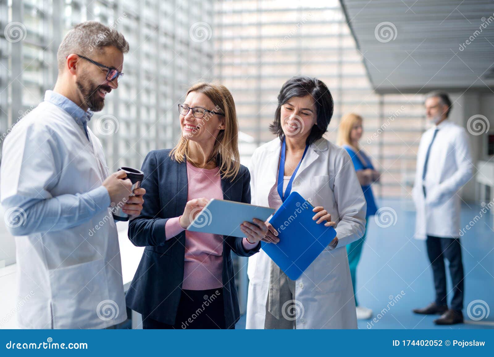 group of doctors talking to pharmaceutical sales representative.