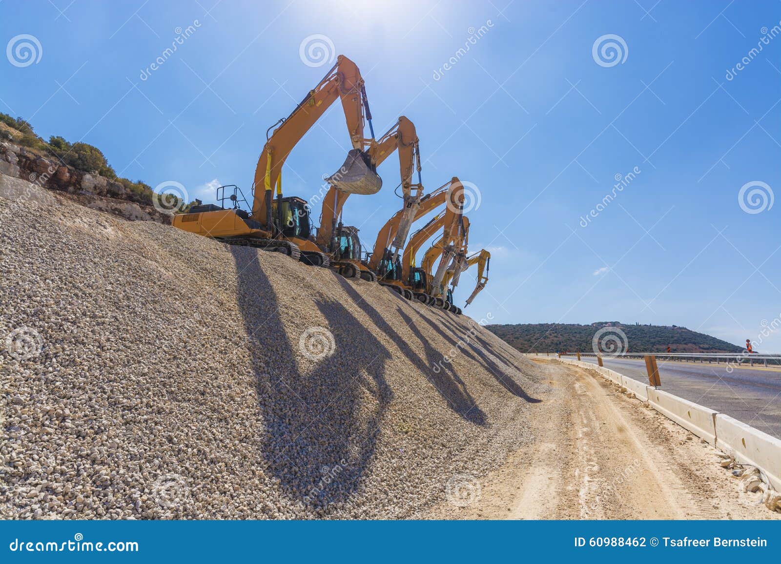 Group of Excavators on Gravel Hill Stock Photo Image of excavator