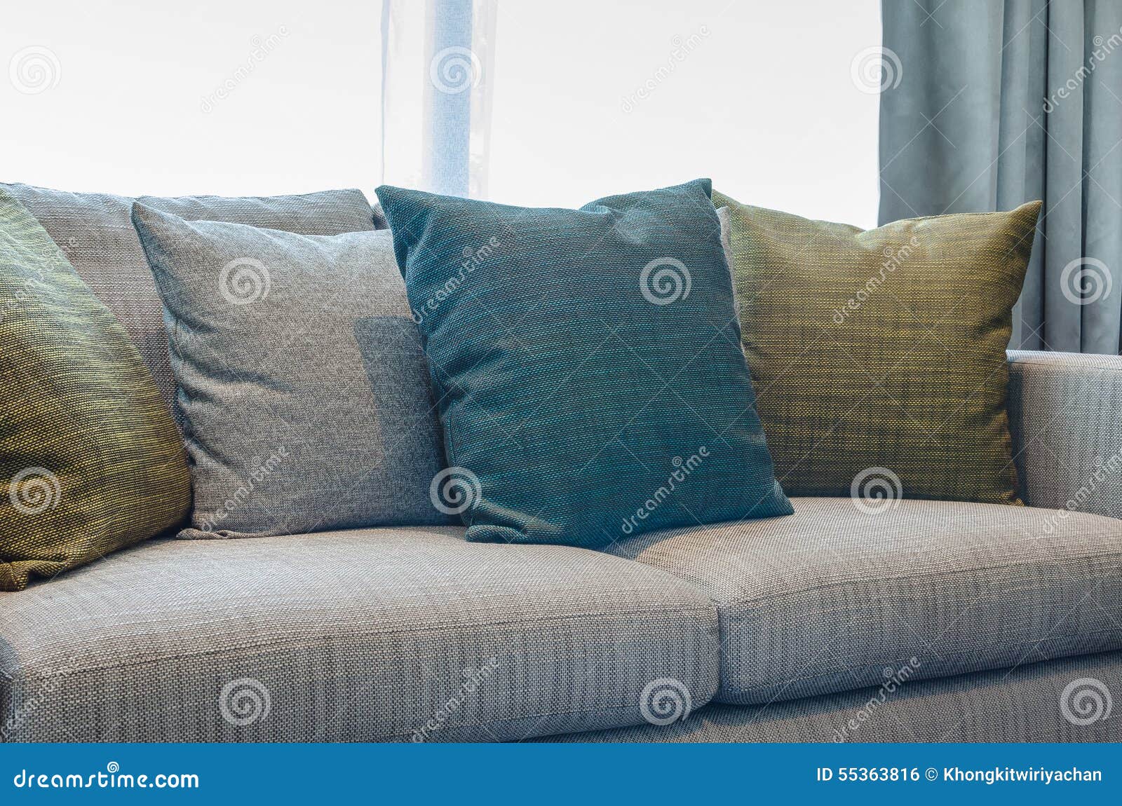 Group of Fabric Pillows on Fabric Sofa in Living Room Stock Photo