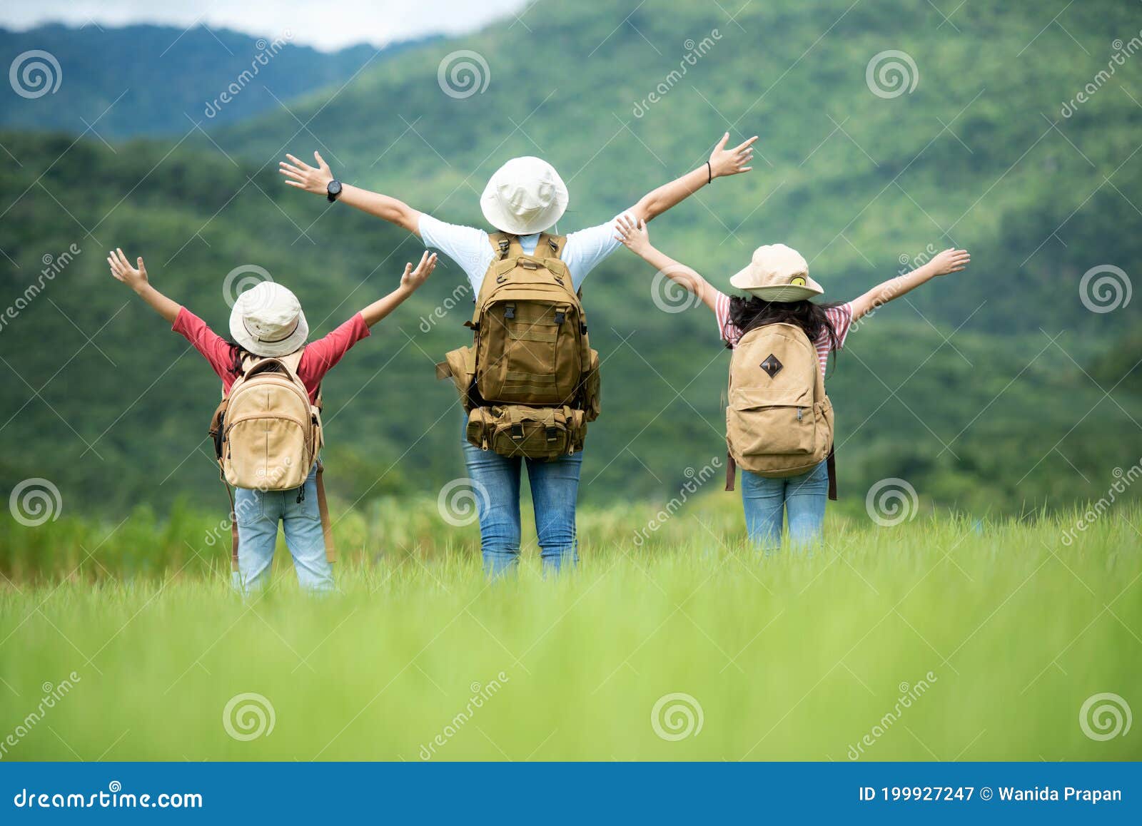 group family children travel nature trips raise arms and standing see mountain outdoors,