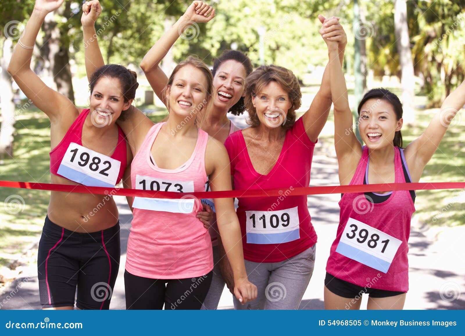 Group of Female Athletes Completing Charity Marathon Race Stock Image