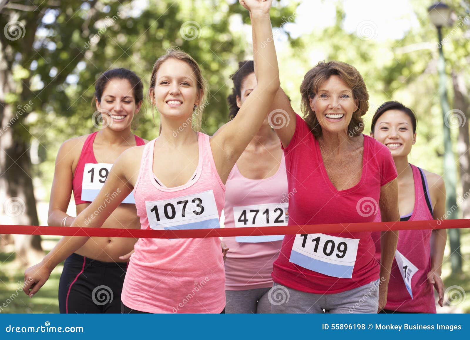 Group of Female Athletes Completing Charity Marathon Race Stock Photo