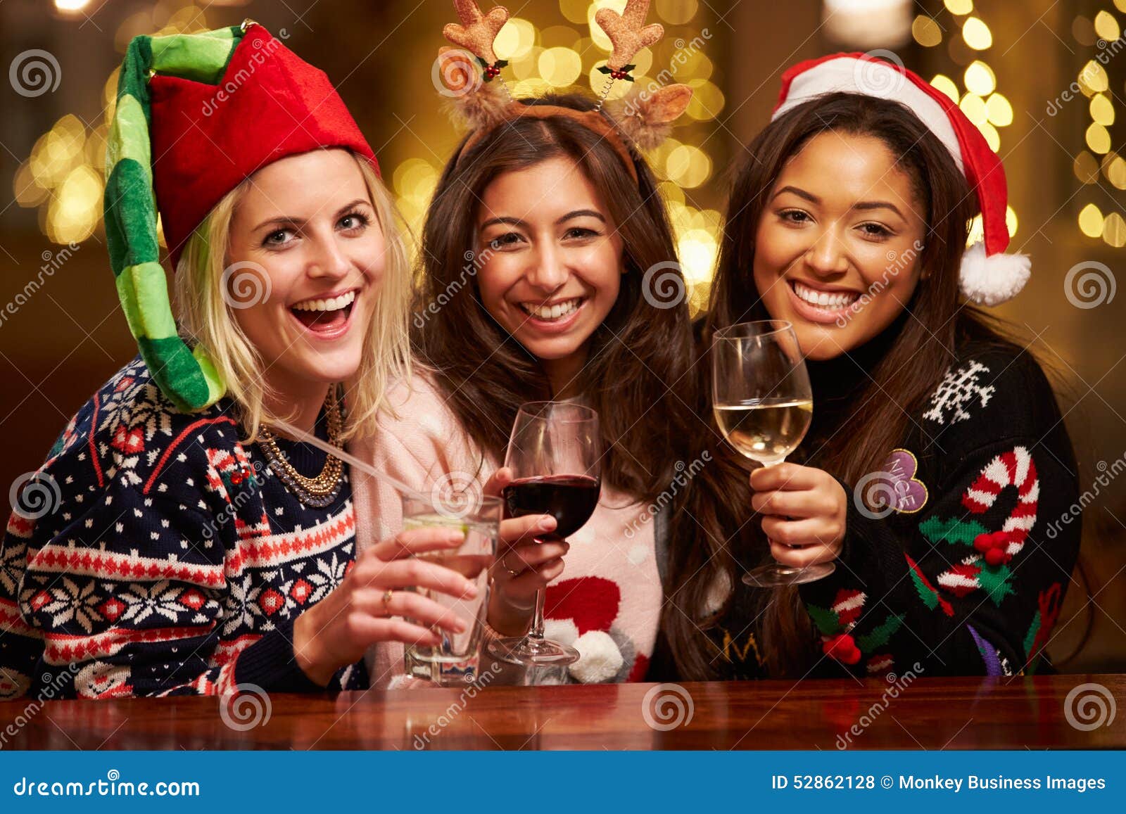 Group of Female Friends Enjoying Christmas Drinks in Bar Stock Photo