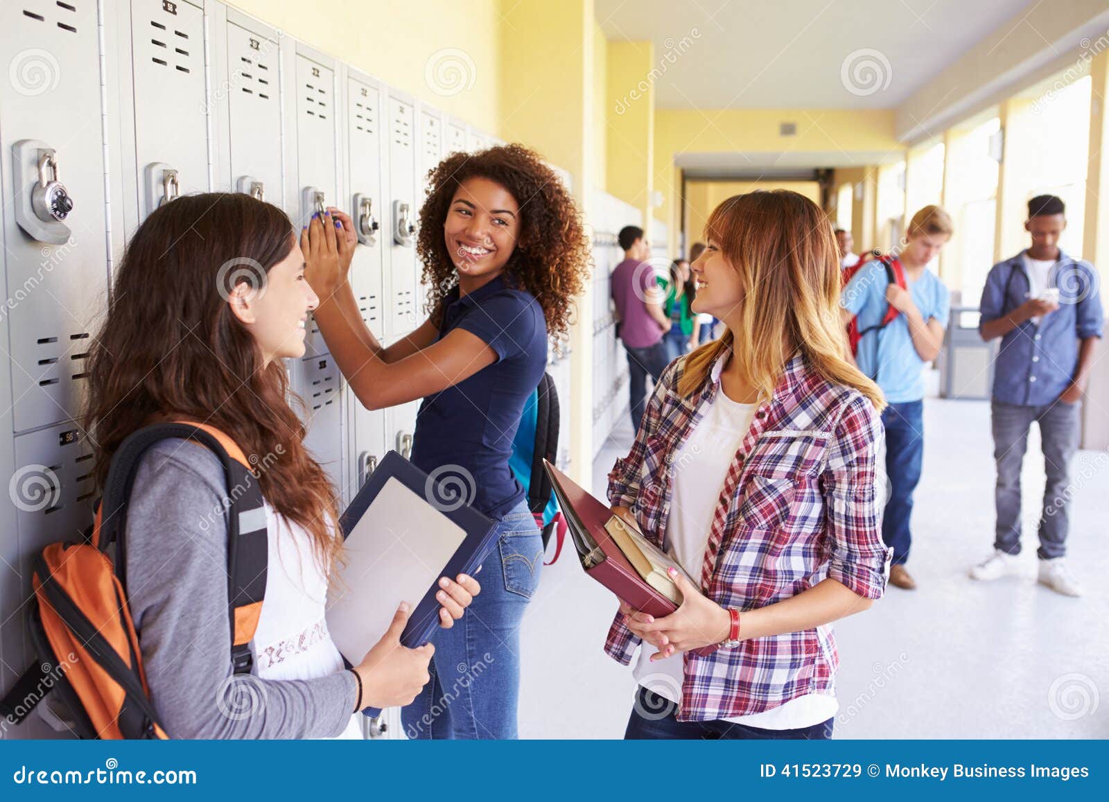 group of female high school students talking by lockers