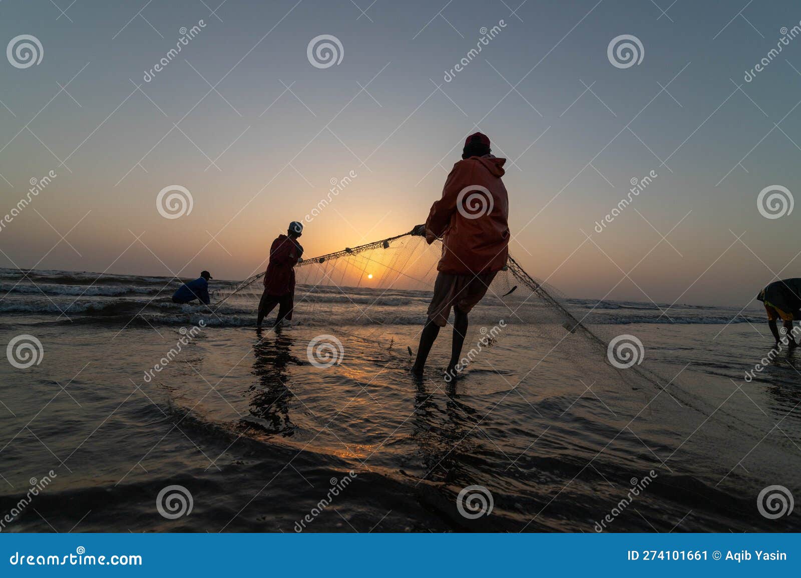 A Group of Fisherman Pulling Fishing Net for Fishing Editorial
