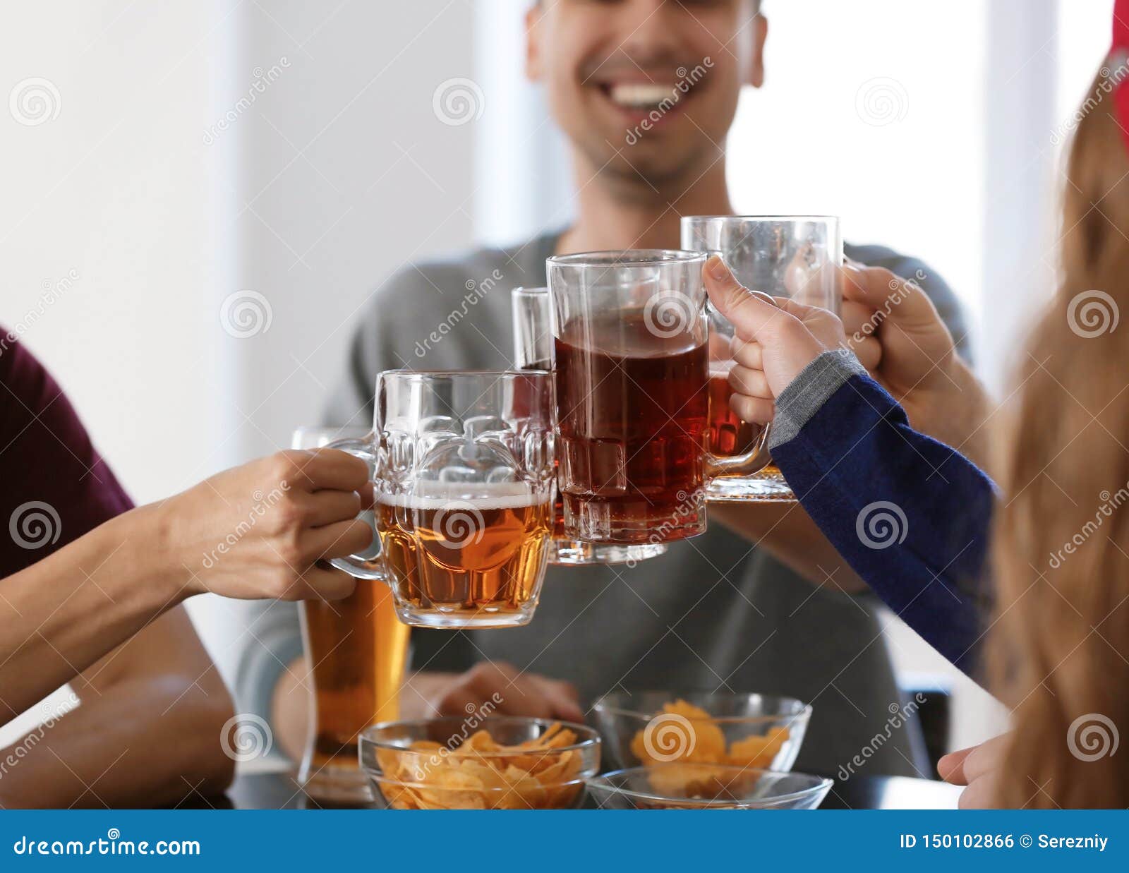Group of Friends Clinking Glasses with Beer in Bar Stock Photo Image
