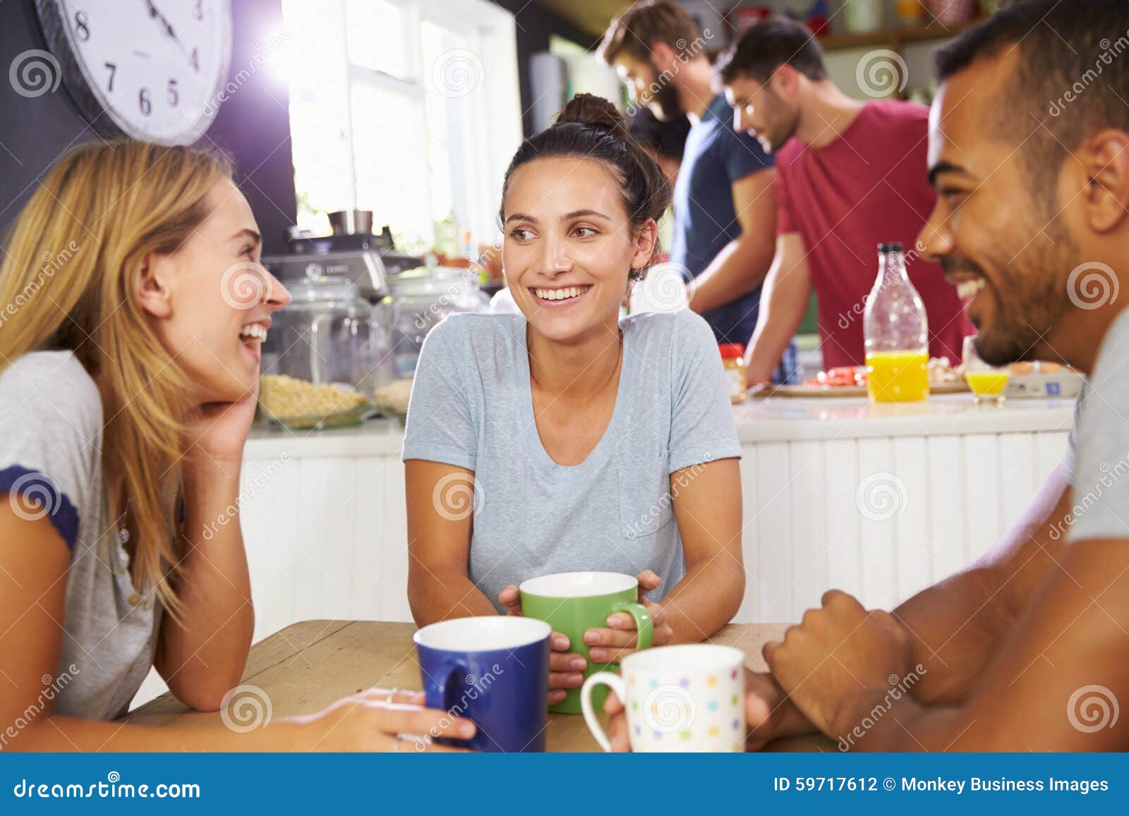 Group of Friends Enjoying Breakfast in Kitchen Together Stock Photo