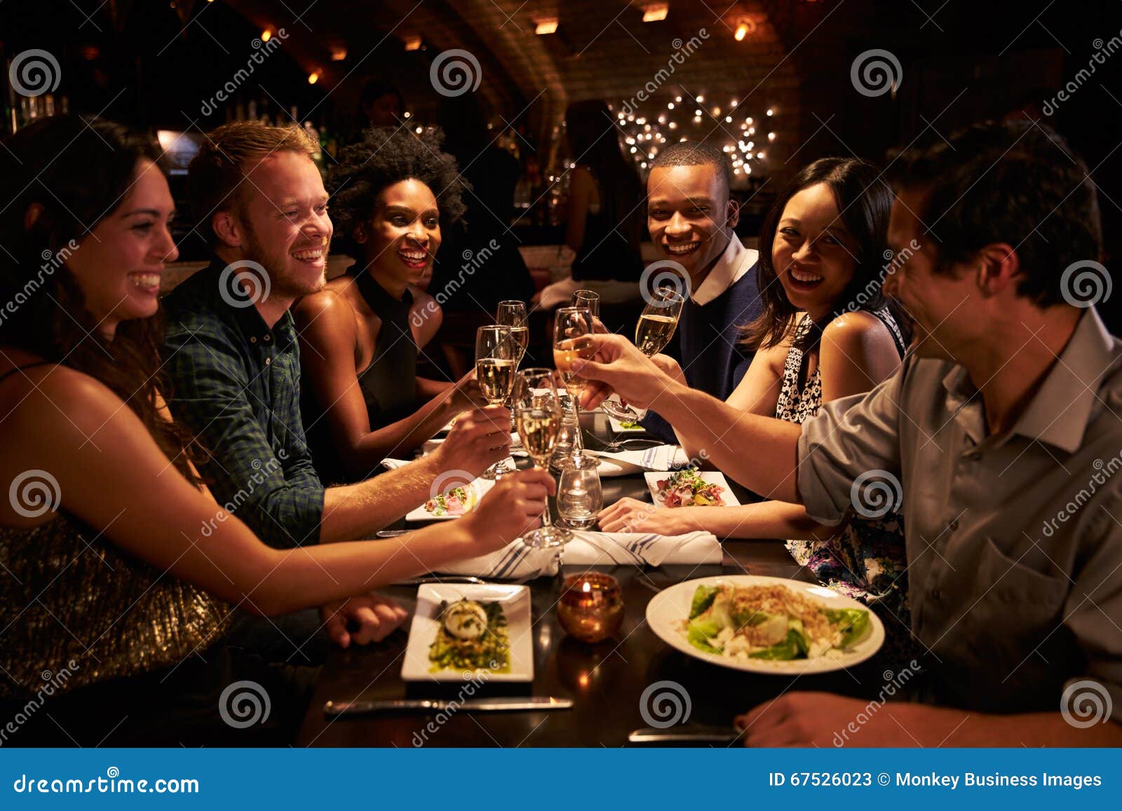 Group Of Friends Enjoying Meal In Restaurant Stock Image - Image of