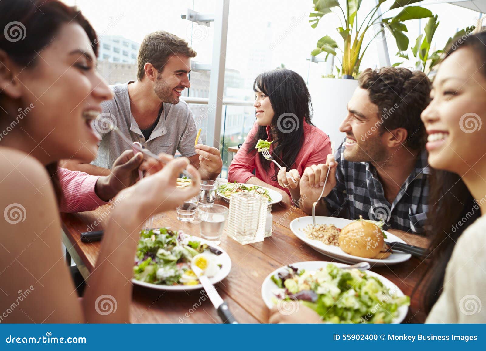 Group of Friends Enjoying Meal at Rooftop Restaurant Stock Photo Image of people, outdoors