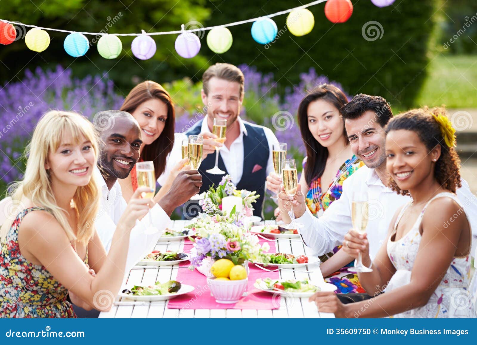 group of friends enjoying outdoor dinner party