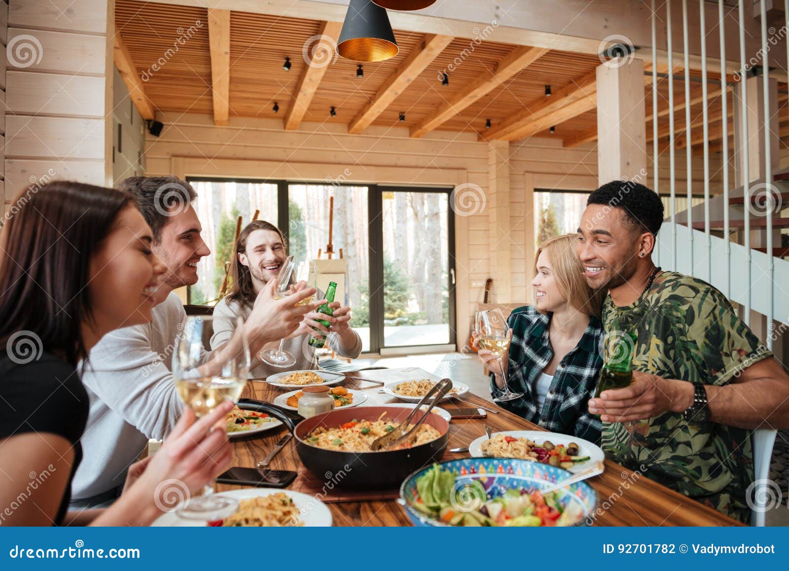 Me And My Friends At The Table Doing Shots Group of Friends Having Dinner and Laughing at the Table Stock Photo