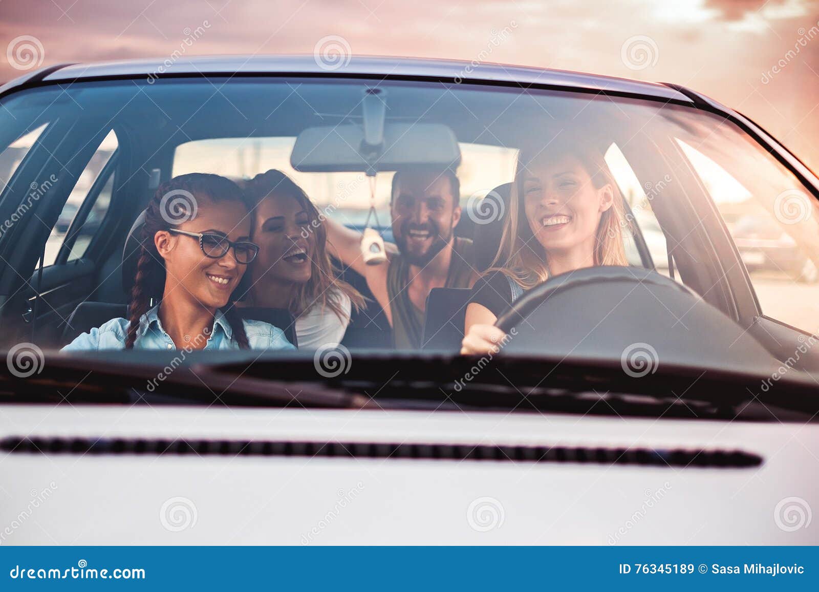 group of friends having fun in the car