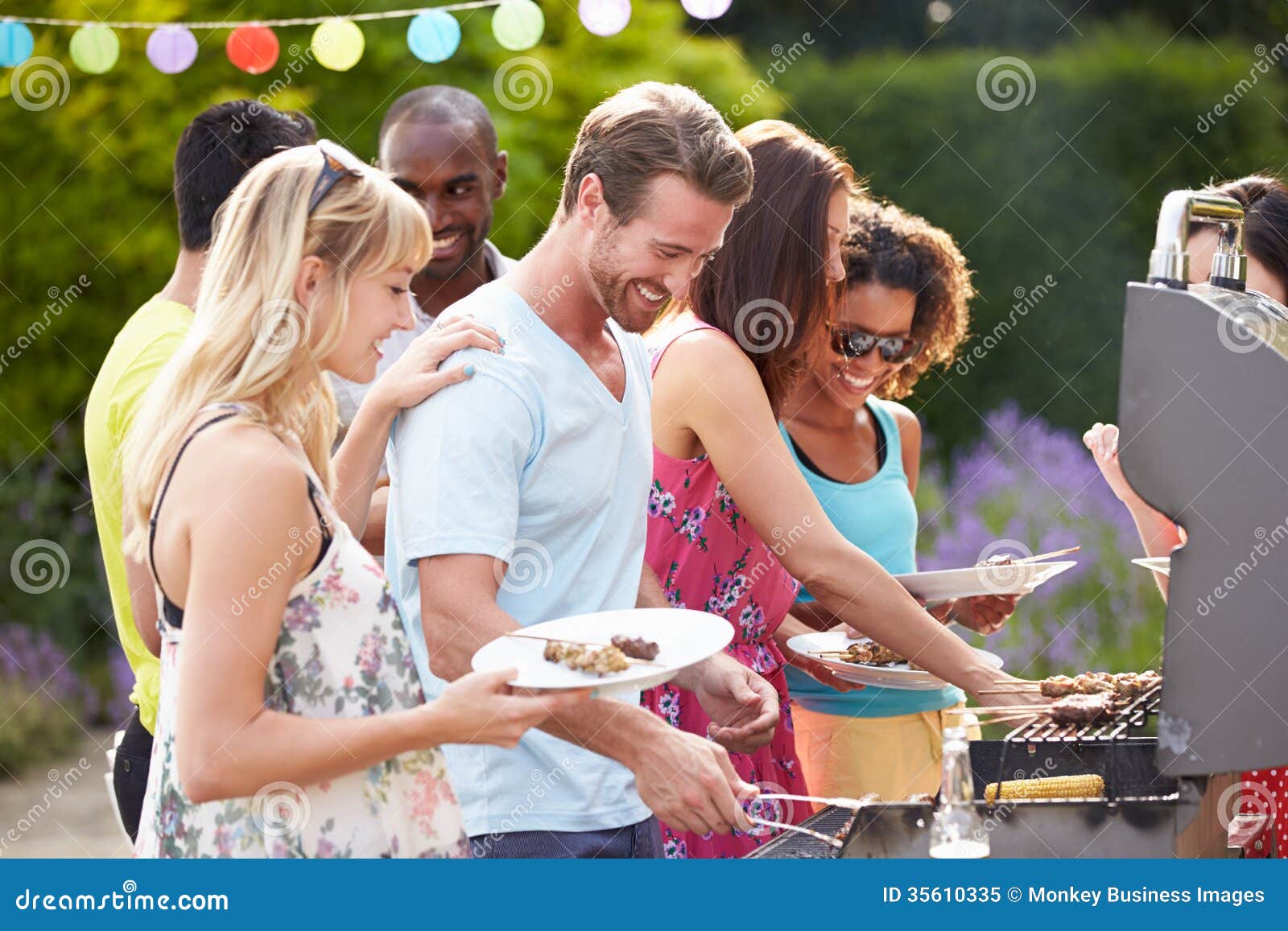 group of friends having outdoor barbeque at home