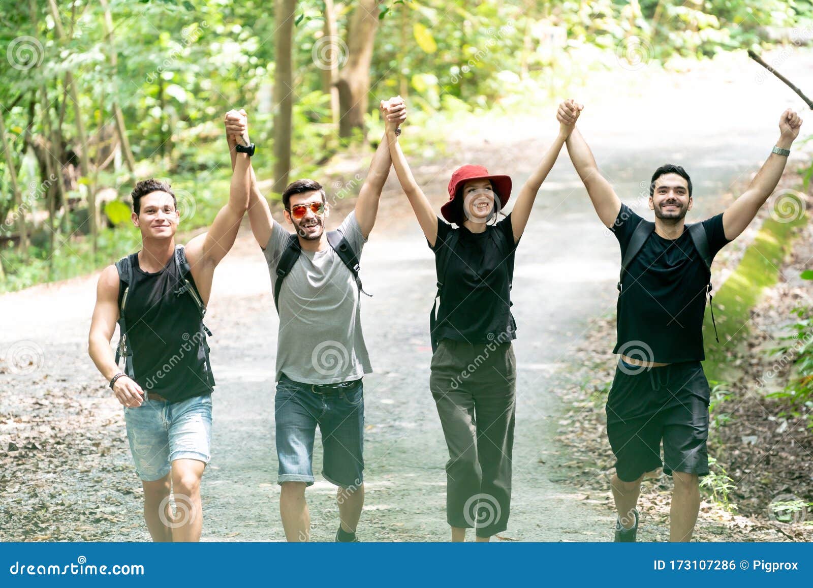 Group Of Friends Hiking Together Through The Forest Stock Photo Image