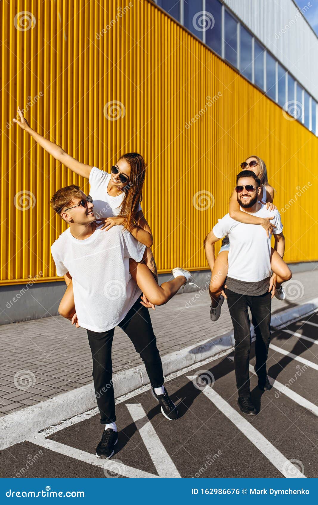 A Group of Friends Laugh and Walk Around the City Center.they Hug Each ...