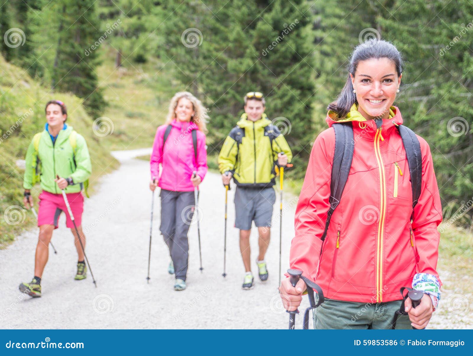 group of friends making trekking excursion in the forest