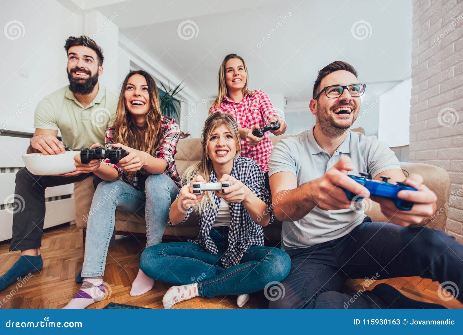 Group Of Friends Play Video Games Together At Home Stock Image Image 