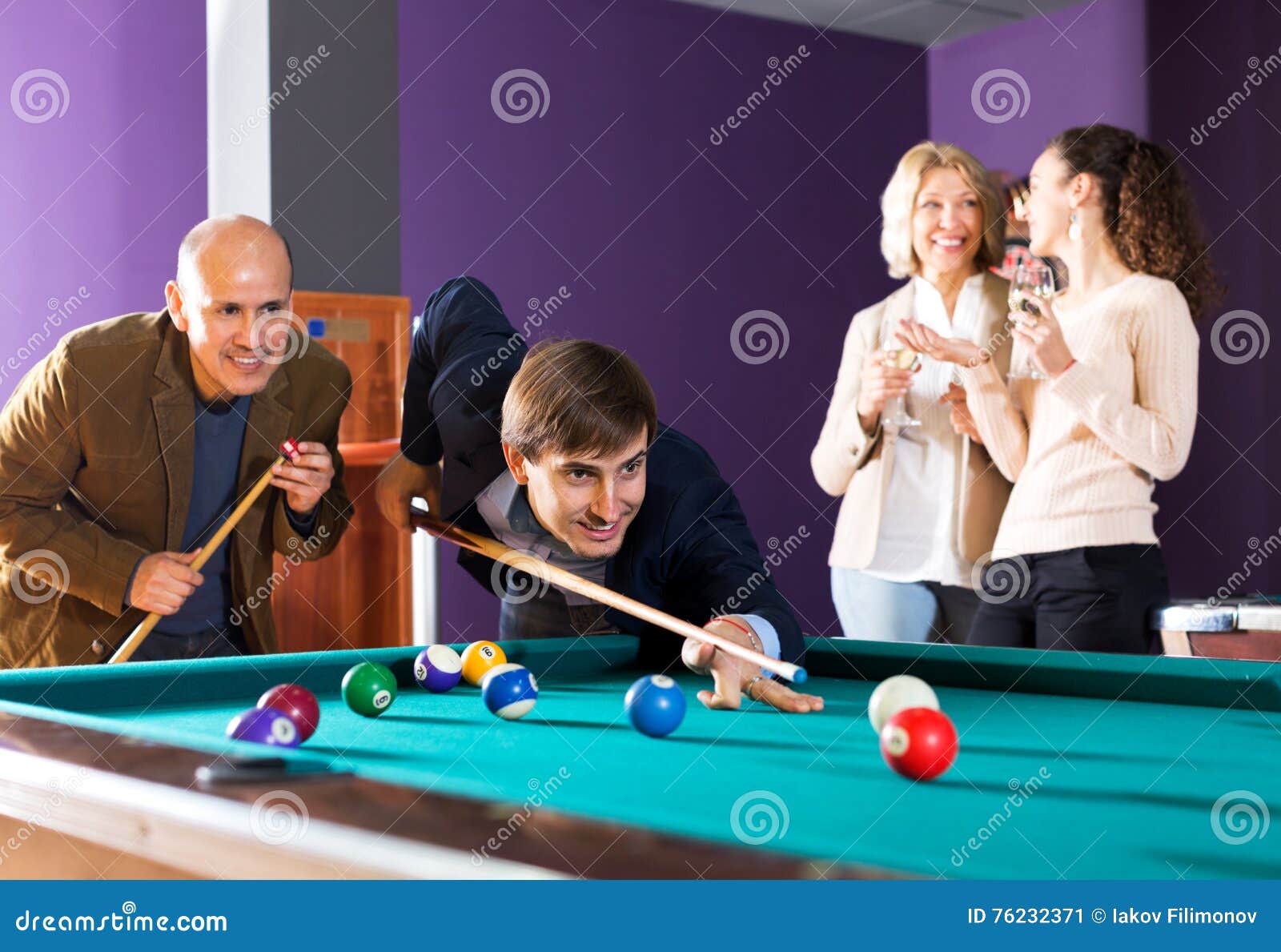 Friends play billiards., Stock image
