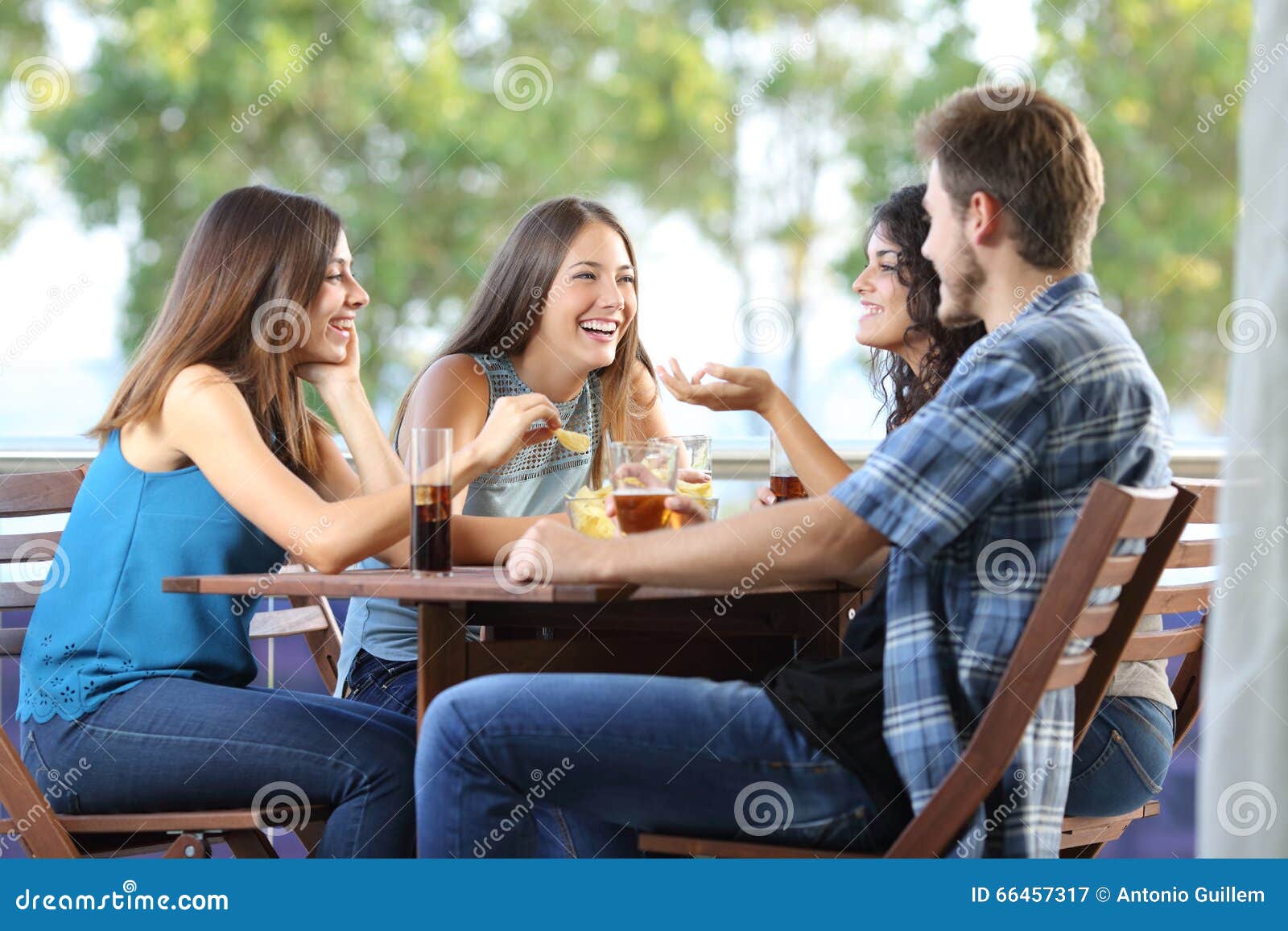 group of friends talking and drinking at home