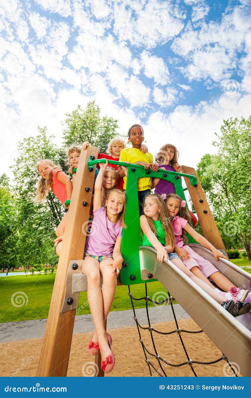 group of friends together on a chute in summer