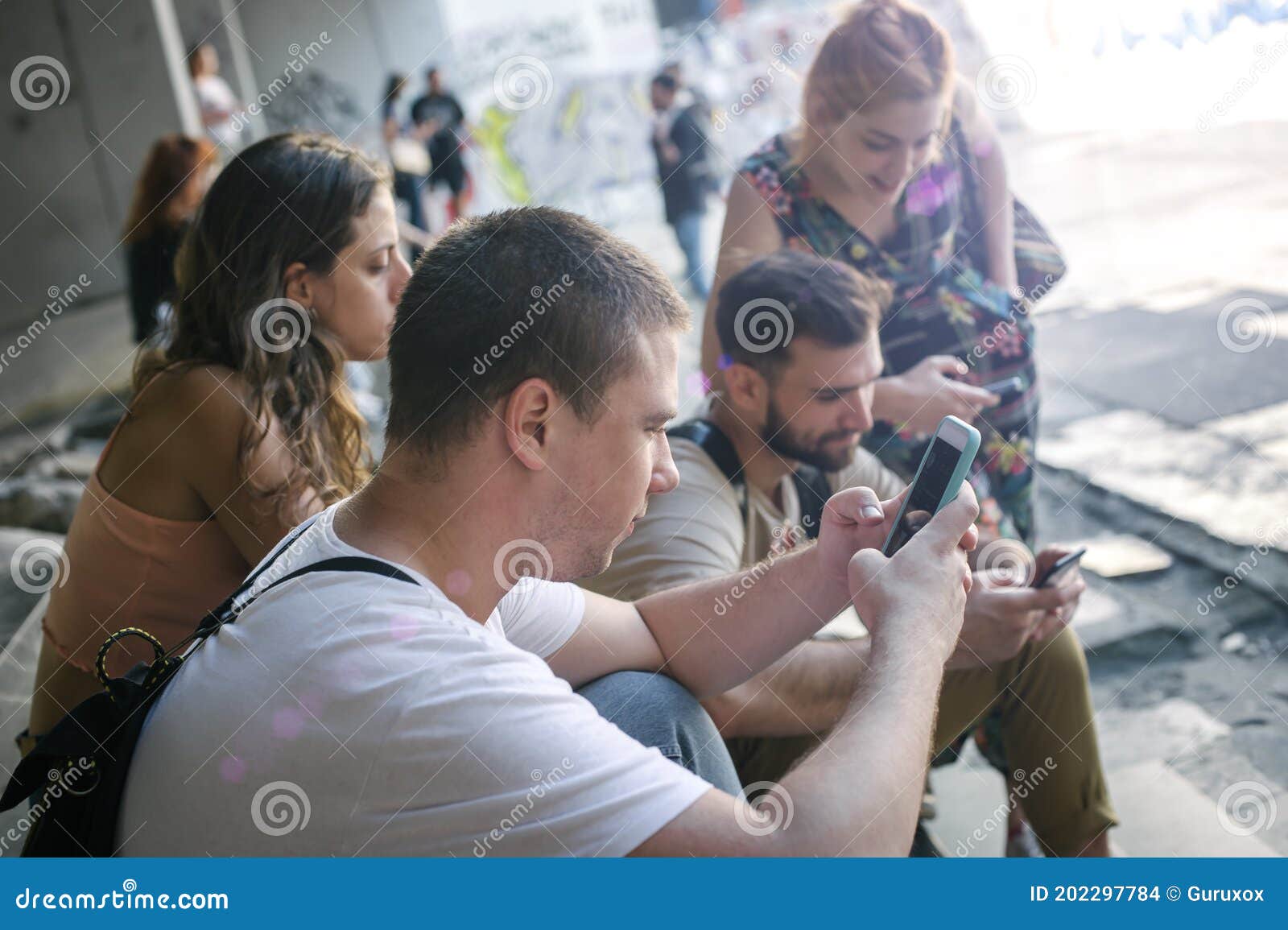 group of friends using smartphones. emotional isolation and technology depresion