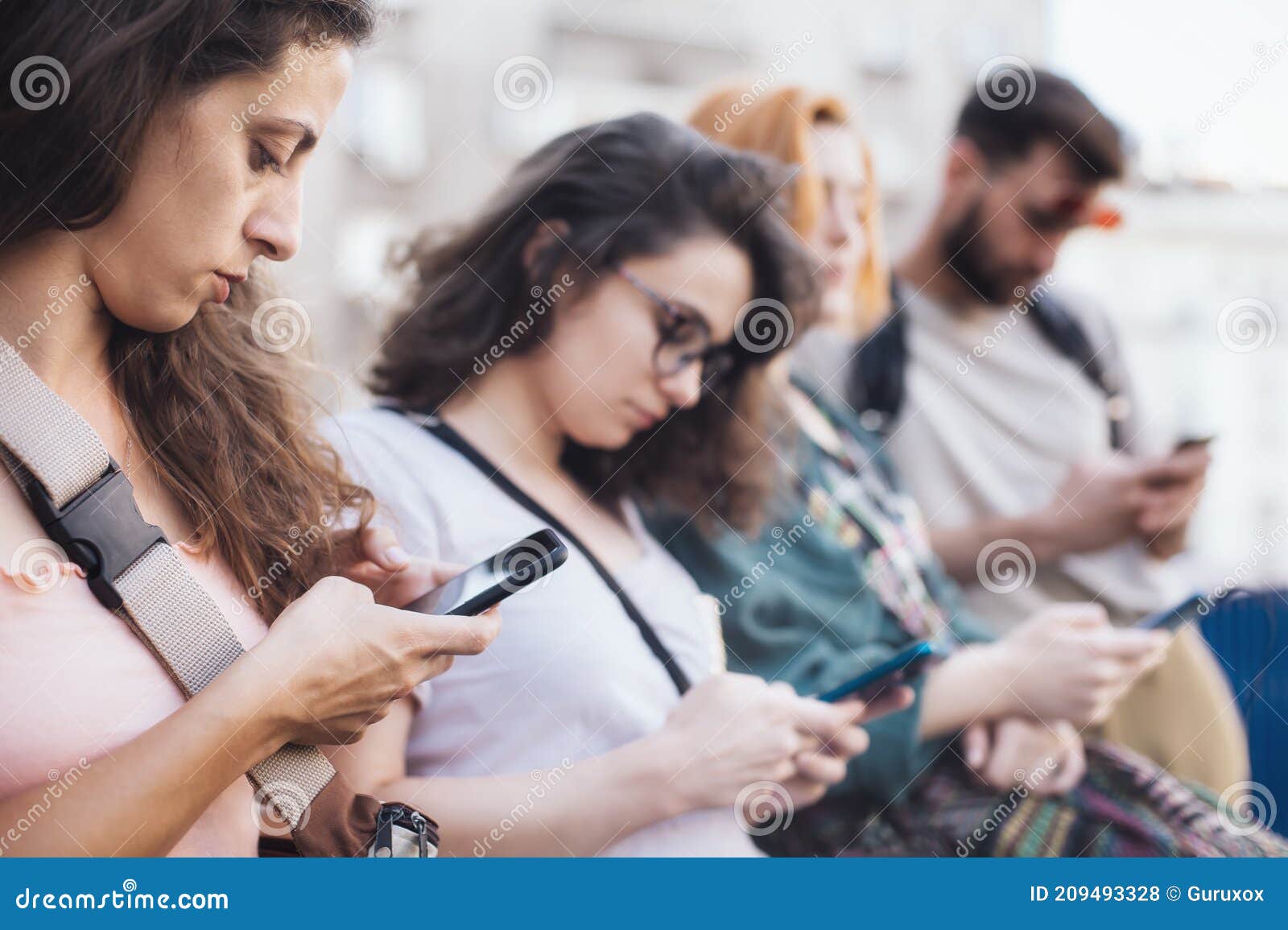 group of friends using smartphones. emotional isolation and technology depresion